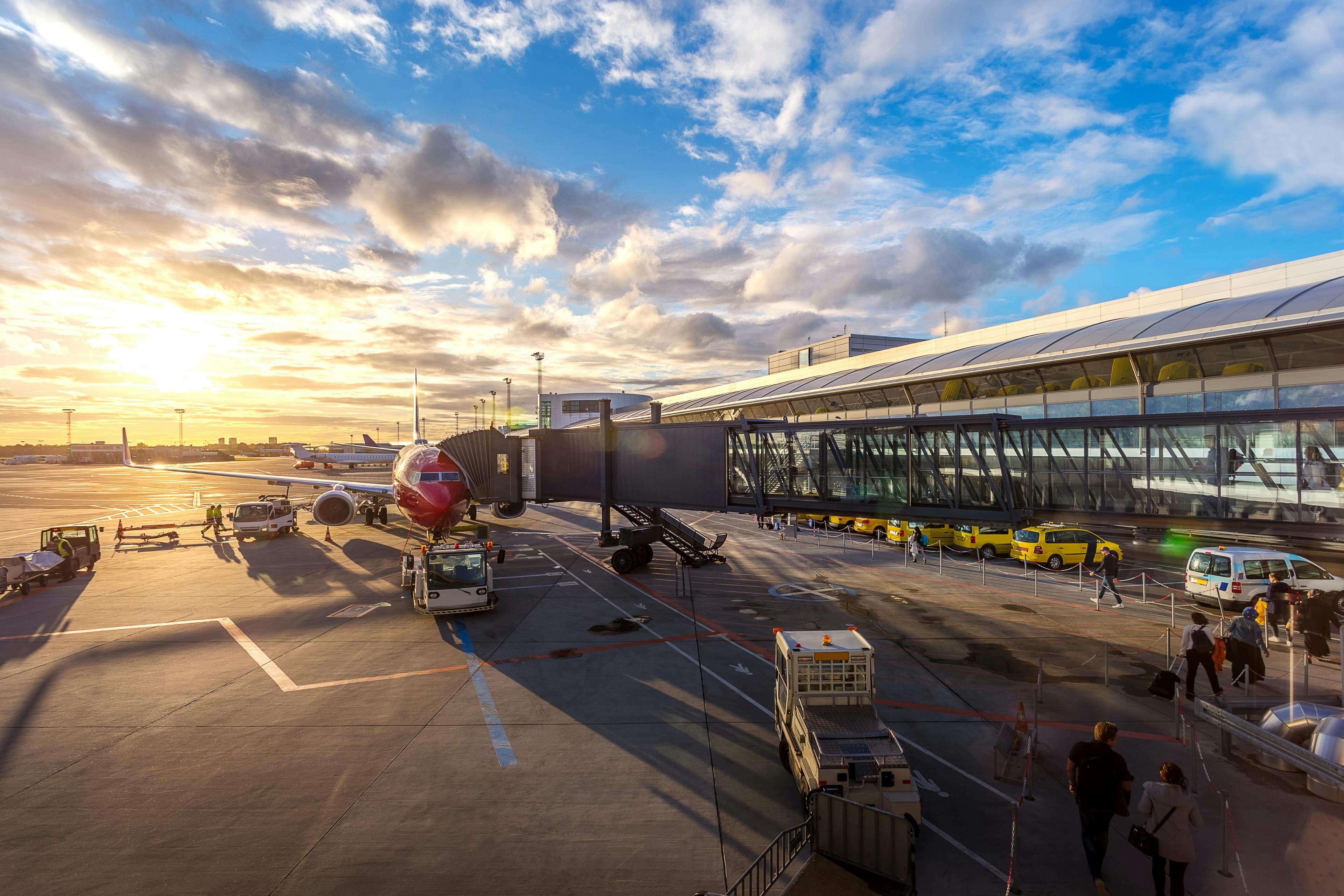 Traveler looking at a departures board with sunrise
